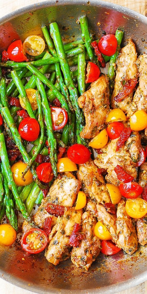 OnePan Pesto Chicken and Veggies â sundried tomatoes asparagus cherry tomatoes. Healthy gluten free Mediterranean diet recipe with basil pesto.