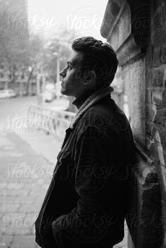 Moody black and white image of a sad man thinking about life. by Koen Meershoek for Stocksy United
