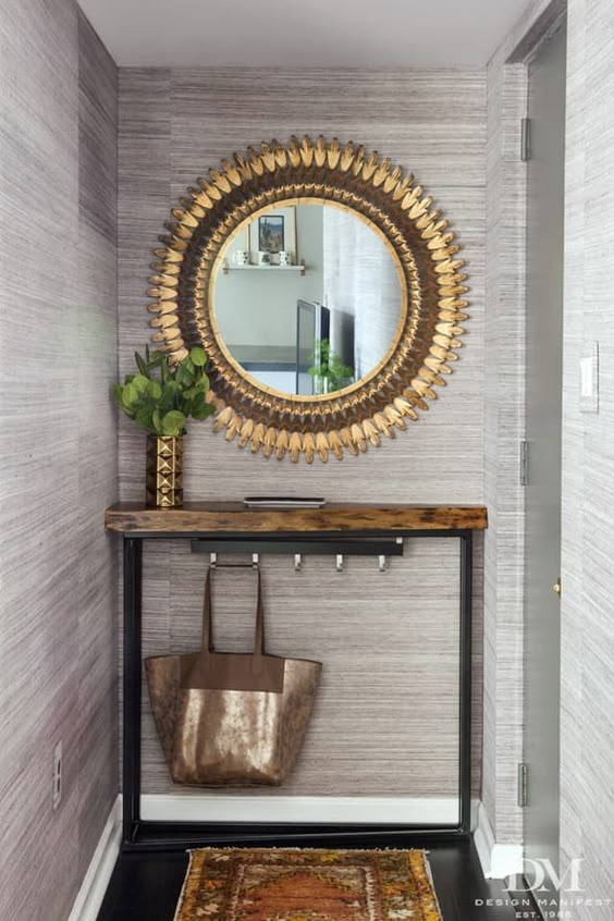 hooks underneath table in foyer -- Foyer Organization Tips + Ideas for Small Spaces | Apartment Therapy