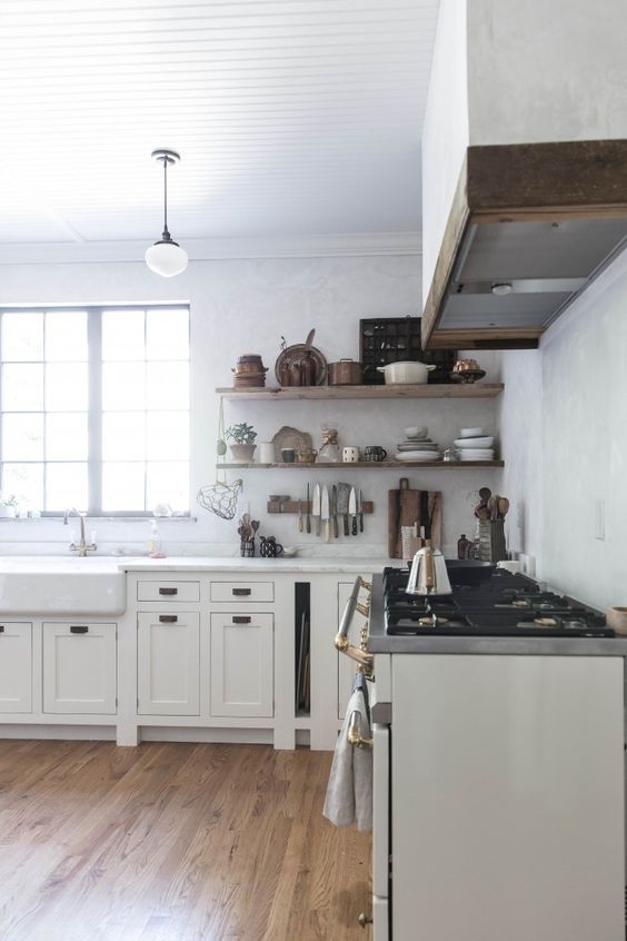 See more of this stunning farmhouse kitchen! Beth Kirby's modern farmhouse style kitchen decor with its rustic shelves, elegant Lacanche Sully range, and apron front farm sink. #whitekitchen #kitchenideas #modernfarmhouse #farmhousekitchen #bethkirby #rusticdecor #kitchendecor