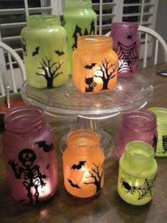 Homemade halloween jars-- LOVE. Paint and dollar tree stickers could recreate this!