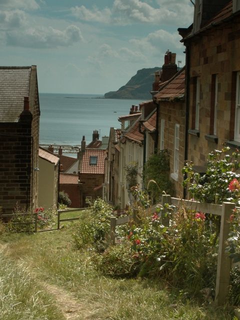 Robin Hood\'s Bay, Yorkshire, England, this magical seaside village clings precariously to a steep cliff sloping down to the North Sea. It is incredibly pretty and reminiscent of years gone by, when smugglers used to ferry their cargo along its winding streets.