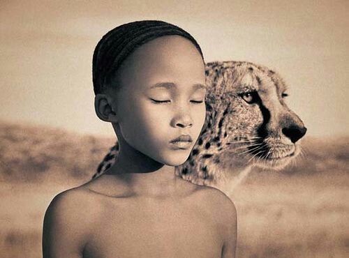Khoisan teenage girl with her cheetah friend.