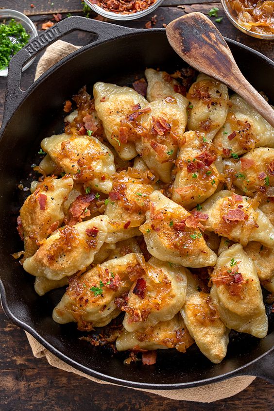 These pierogi with potato and sauerkraut are deliciously savory with a bit of a tangy bite, and the perfect European comfort food! | thecozyapron.com #pierogi #pierogirecipe #pierogis #pierogidough #potatopierogirecipe #potatopierogi #pierogiwithsauerkraut #sauerkrautpierogirecipe #pierogisauerkraut