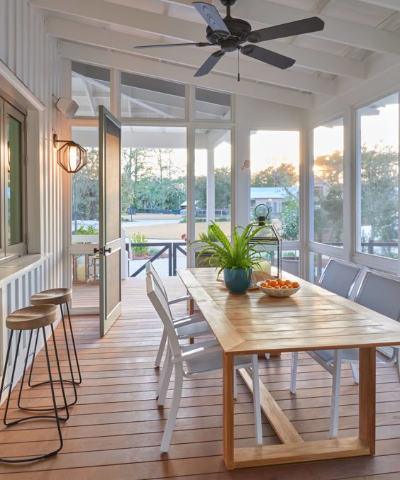 Is it beachy? Is it a farmhouse? Yes and yes. A perfectly casual beachy farmhouse screen porch with dining table and chairs. #screenporch #outdoordining #farmhouse #beachy #coastal #decoratingideas