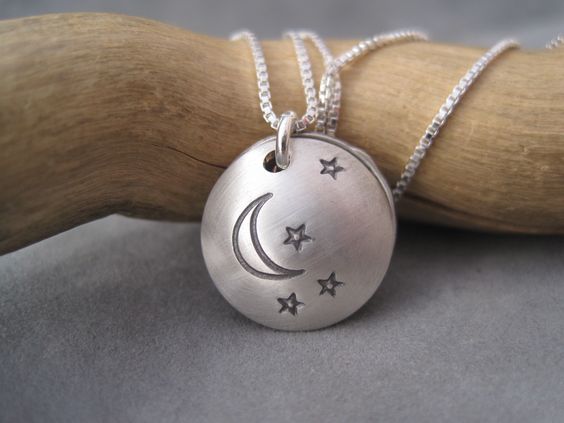 "This sweet clamshell style locket has 2 X 5/8\\" sterling silver discs which have been domed to create a lovely keepsake. Inside is a SURPRISE!: a miniature vintage copper penny (dated 1964) and the words, \'heaven cent\' or \'from heaven\'. According to the poem, a found penny is a sign from above, an angel watching over you. Your necklace will come with a copy of the poem. The penny is approximately 3/8\\" in size. The outside, top of the locket can be stamped with 3 stars or with a moon and smalle