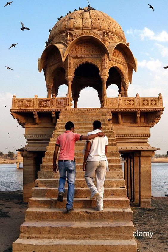 Two men visit the Gadi Sagar lake in Jaisalmer , India Rajasthan #India #travel
