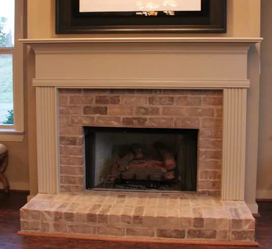 Wood plank wall around fireplace but with lighter faded brick and the built up hearth | Family Room | Pinterest | Wood plank walls