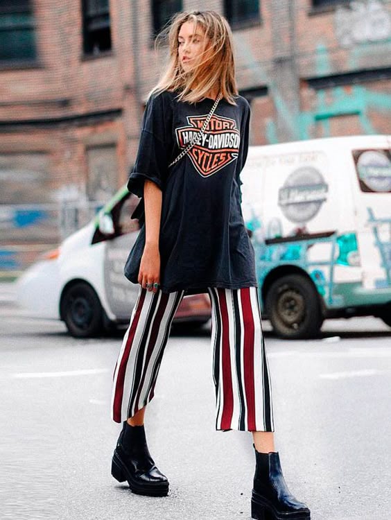 Combine a T-Shirt vintage com calça listrada e bota.