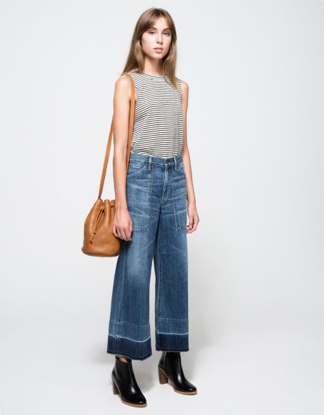From Citizens of Humanity, mid-rise wide-leg cropped jeans in retro mid-blue wash. Features zipper fly with branded top button, belt loops, whiskering and faded detailing throughout, deep boxy front pockets, back pockets, hem wash detail, unravel hem and