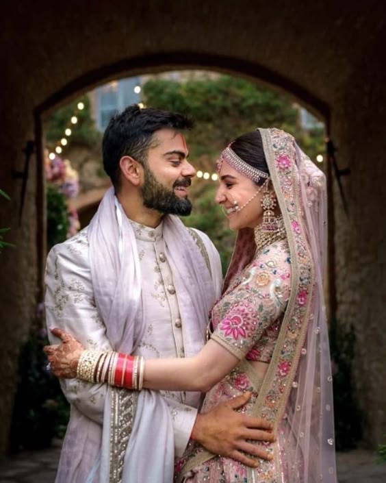 Virat Kohli in white sherwani to match the pastel pink lehenga of Anoushka Sharma