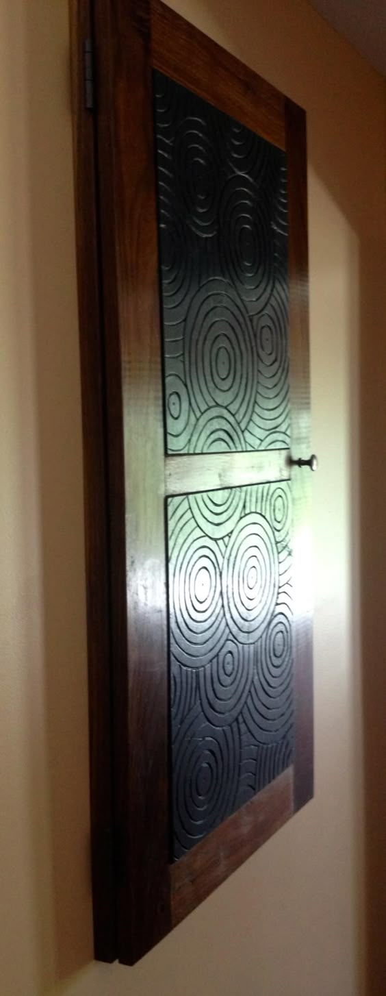 contestants martha and alex built a custom pine door to cover the electrical panel in the first floor office at the renovated comfort breeze condo.