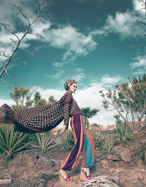 This is a unique look because of the interesting color palette as well as the pose of the model. The pants make a huge statement as well as the cape. #beautyfashion