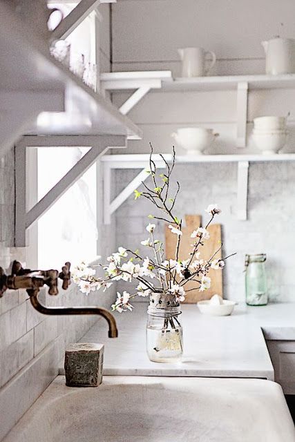 White kitchens design ideas in photos we can't stop pinning! White kitchen with dreamy French farmhouse style, marble subway tile, stone sink, and open shelving. #whitekitchen #dreamywhites #shelves #stonesink #farmhousestyle #frenchfarmhouse