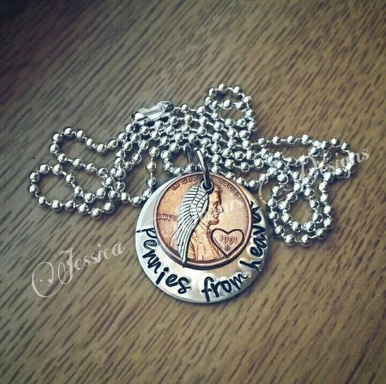 "It is often a belief that our passed loved ones will leave pennies or other coins in unusual places along our paths as a sign that they are watching over us. This necklace is a special reminder that our loved ones are always watching over us. This custom designed necklace is a nice piece of memorial jewelry that will easily become your go-to piece. I\'ve hand stamped a 1\\" silver disc to say \\"Pennies from Heaven\\" and added a penny with a heart stamp around the year, along with a small angel wi