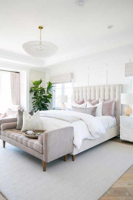 elegant master bedroom decor with pink velvet bench at end of bed, neutral bedroom design, neutral Master Bedroom decor with white walls, white bedding, nightstand decor, and upholstered headboard, traditional glam bedroom decor #dreambedroom
