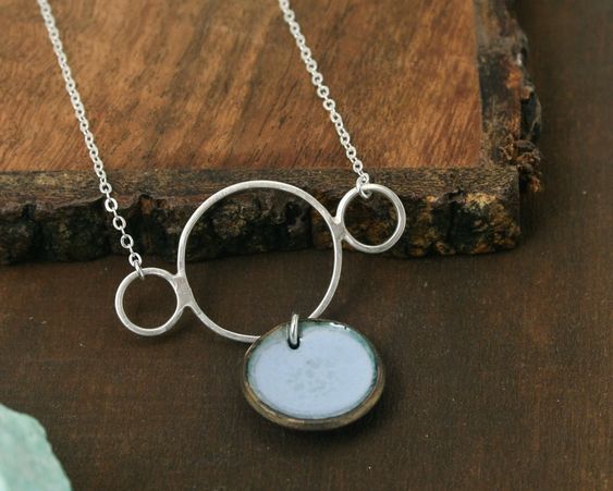 One of a kind necklace with fog enameled penny suspended from sterling silver rings. Available on silver or sterling chain, adjustable 16-18" Worn on longest length in image.Pendant measures 1.5"Penny jewelry is a great copper anniversary gift.Many buy my enamel penny jewelry as a "pennies from heaven" gift, to remember a loved one.You can order these with a custom date (between 1940 and 1982) buy adding this custom date upgrade here