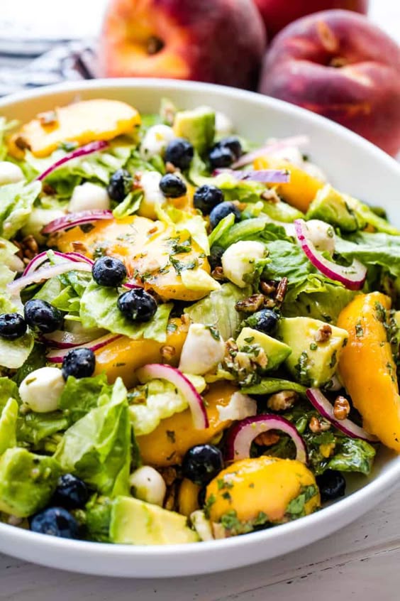 Meet your new favorite salad! Summer Peach Salad is full of the sweet flavors of late summer with peach, blueberry, avocado, mint, mozzarella and more! #thestayathomechef #summerpeachsalad #summersalad #saladrecipe #peach