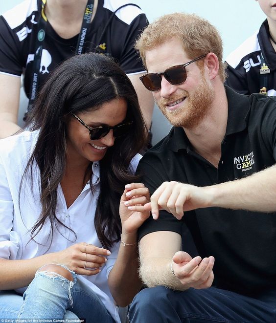 Keeping her entertained: The Suits star was seen laughing with her royal partner as she placed an affectionate hand against his arm