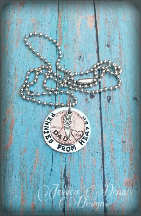 "It is often a belief that our passed loved ones will leave pennies or other coins in unusual places along our paths as a sign that they are watching over us. This necklace is a special reminder that our loved ones are always watching over us. This custom designed necklace is a nice piece of memorial jewelry that will easily become your go-to piece. I\'ve hand stamped a 1\\" silver disc to say \\"Pennies from Heaven\\" and added a penny with a heart stamp around the year, along with a small angel wi