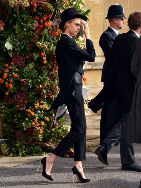 Model Cara Delevingne leaves St. George’s Chapel after attending the wedding of Britain’s Princess Eugenie of York and Jack Brooksbank on October 12, 2018. By Matt Crossick/Getty Images.
