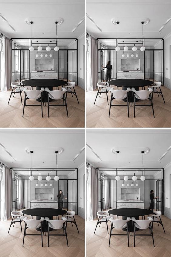 A Black-Framed Glass Wall Separates The Kitchen From The Dining Room In This Apartment