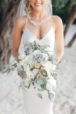 I wanted a very natural-looking bouquet â all white florals with lots of greenery throughout for our Key Largo wedding. I included seeded eucalyptus and succulents., along with white hydrangeas and roses.