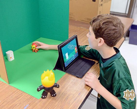 Eighth-grader Ethan Doman adjusts a character a fraction of an inch before shooting another frame in front of a green screen as he makes a stop-motion animation video at Glen Crest Middle School in Glen Ellyn on Thursday, Jan. 7, 2016. Bill Ackerman for Shaw Media