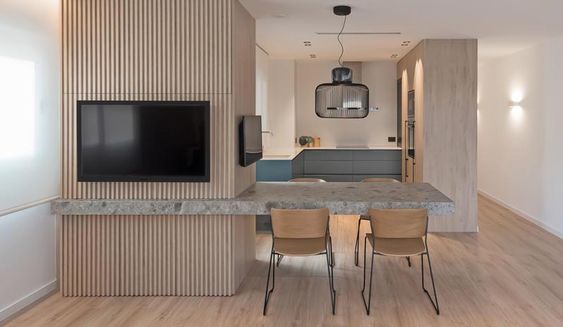 A Cantilevered Dining Table Separates The Kitchen And Living Room In This Apartment