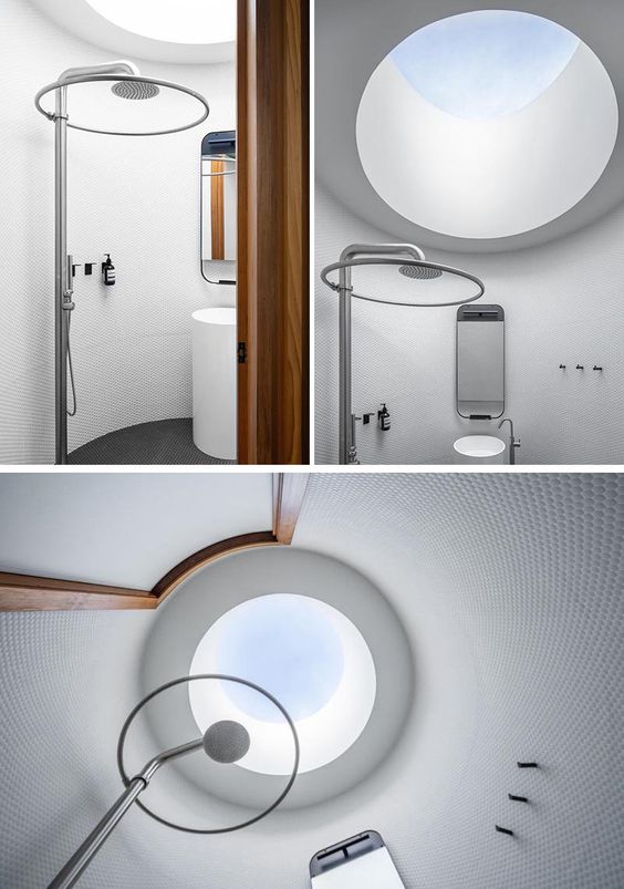 A Round Bathroom Was Designed For This Glass Enclosed Pool House