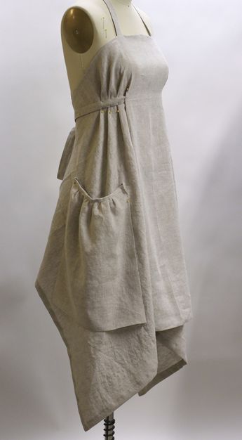 VERMONT APRON COMPANY 077, http://www.theaprongazette.com/linen/, showing apron pinned in place. Bias cut, pleats held by end of waist tie sewn over the pleats. Gathered pockets are just pinned in place here, but sewn down on finished apron. See front view as well.