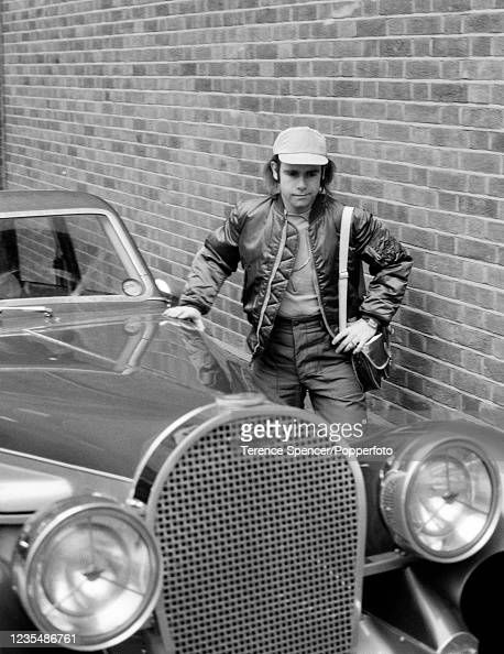 British singer Elton John poses with his new car, a Panther De Ville,...