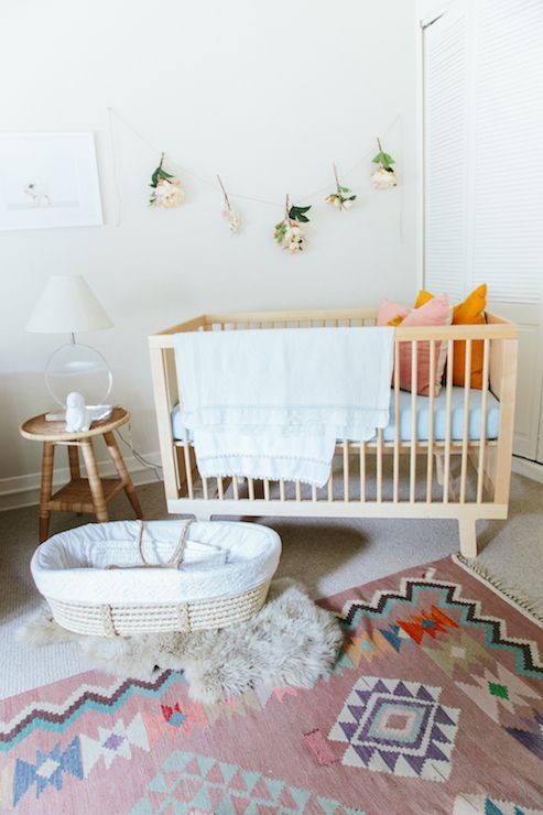 Adorable Nursery Features A Modern Wood Crib And Woven Moses Adorable Nursery Features A Modern Wood Crib And Woven Moses Basket Atop Sheepskin Layered Over Pink Kilim Rug Aztec Tribal Pinterest