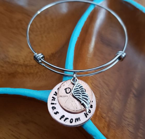 pennies from heaven bangle bracelet What the exact same thing but on a necklace instead Click on the link below to view the necklace style https://www.etsy.com/listing/261881751/pennies-from-heaven-necklace-handstamped Handstamped onto a thick copper disc penny stamped with name up to 4 letters I have pennies from 2000 and up YOU pick the year Adjustable stainless steel bangle bracelet All of my items are hand stamped, so each piece is unique. Hand stamping is a process where each letter is indi