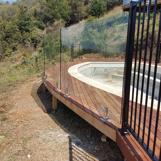 Curved Wooden Pool Deck With Glass Pool Fencing Decks Around Pools Wooden Pool Deck Timber Deck