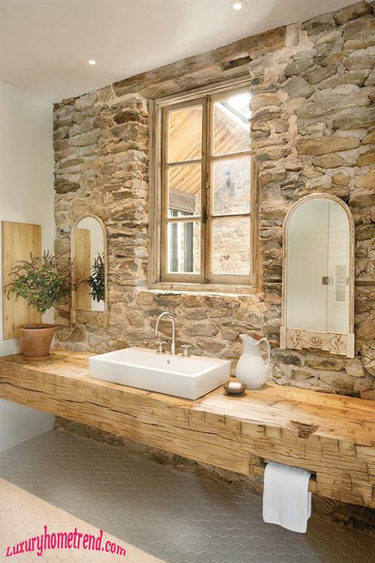 Sandstone wall cladding rubble construction coupled with an organic weathered timber bench top helps create a stylish rustic bathroom.SCOTTS OTHER STONE STYLE
