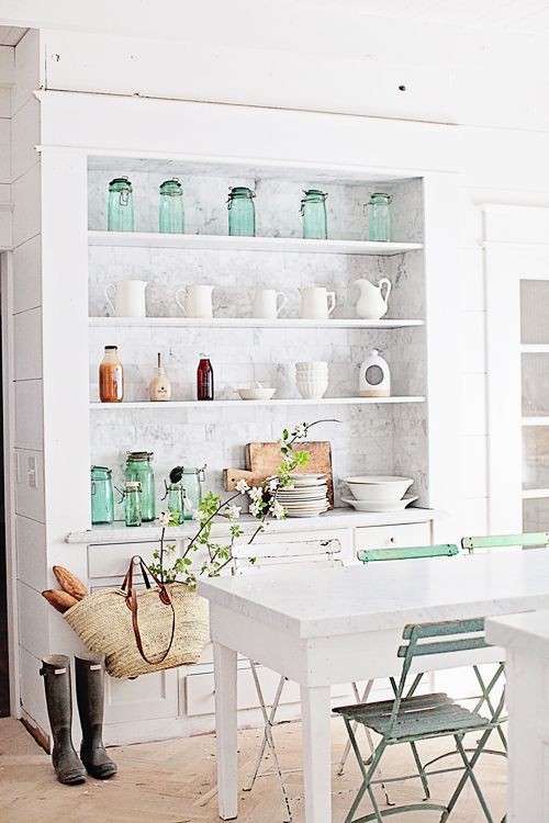 White kitchens design ideas: Farmhouse style white kitchen with white shelves and market basket. Dreamy Whites. #whitekitchen #farmhousekitchen #pastels #frenchfarmhouse #openshelves
