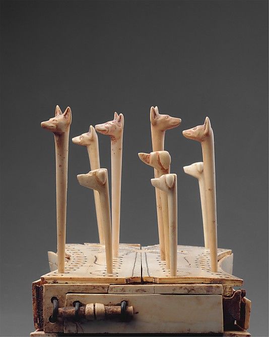 Board Game of Hounds and Jackals, Ivory and Wood The board is raised on 4 bulls' legs. A drawer with a bolt to store the playing pieces. "Egyptians likened the intricate voyage through the underworld to a game." ca. 1814–1805 BCE.  Thebes. Tomb of Reniseneb (CC 25), at bottom of shaft. MET.