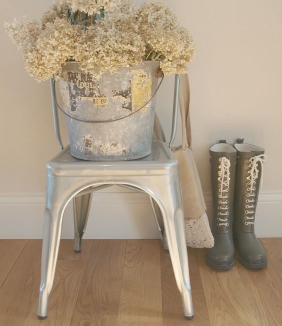 Silver French Tolix chair with vintage galvanized bucket of dried hydrangea/Ilse Jacobsen boots with laces/white oak hardwood flooring. Come be inspired on Hello Lovely by 7 Low Cost Timeless Decorating Ideas That Don't Involve the Dollar Store As Well As Photos Around My House.