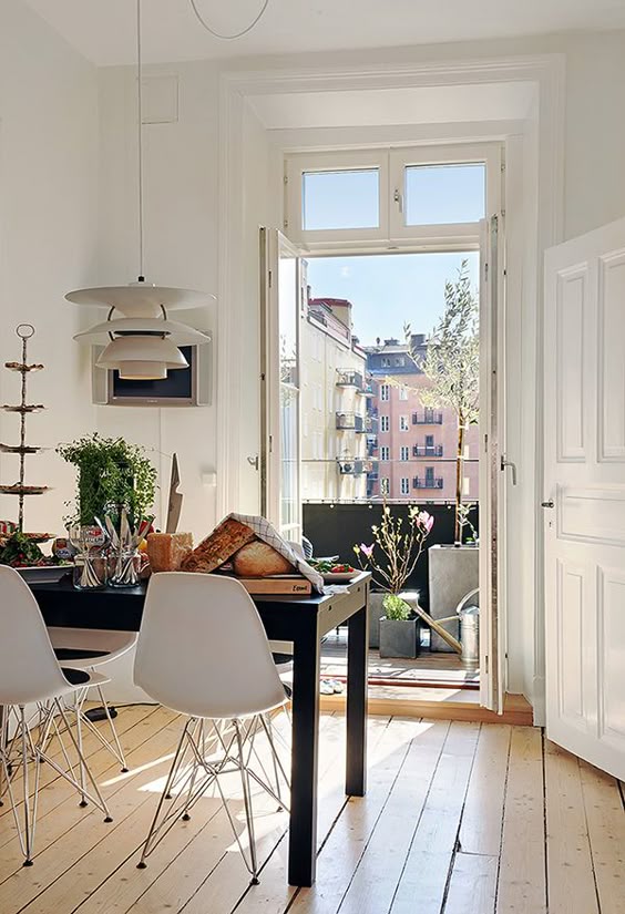 Paris apartment Charming Midcentury Modern interior design in a Paris apartment with the French doors wide open to the city!