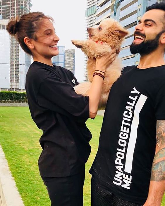 Virat Kohli and Anushka Sharma play with their dog