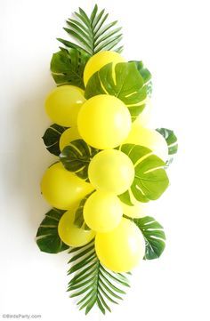 DIY Balloon and Fronds Tropical Party Table Centerpiece Garland - learn to make this easy table decor for your birthday table, party photo booths or summer party decorations!