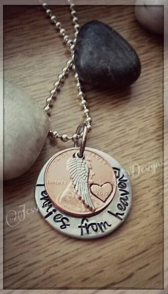 "It is often a belief that our passed loved ones will leave pennies or other coins in unusual places along our paths as a sign that they are watching over us. This necklace is a special reminder that our loved ones are always watching over us. This custom designed necklace is a nice piece of memorial jewelry that will easily become your go-to piece. I\'ve hand stamped a 1\\" silver disc to say \\"Pennies from Heaven\\" and added a penny with a heart stamp around the year, along with a small angel wi