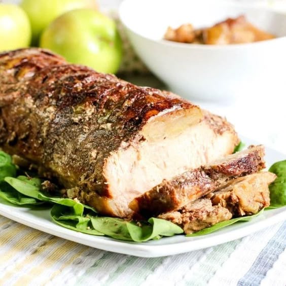 Slow cooker pork loin that is a tender pork loin with the sweet taste of apples and a sprinkle of cinnamon. This slow cooker apple pork loin is fantastic. Honey, Granny smith apples, and more are what really elevate the flavor of this pork loin recipe. #dinner #slowcooker #crockpot #pork #easy #apple #honey