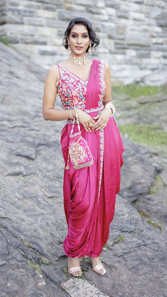 This is a readymade dhoti saree with the pallu attached! Just slip it on and zip it up! Paired with a sleeveless blouse and a waist belt! The multicolor resham embroidery is highlighted with gold sequin embroidery!