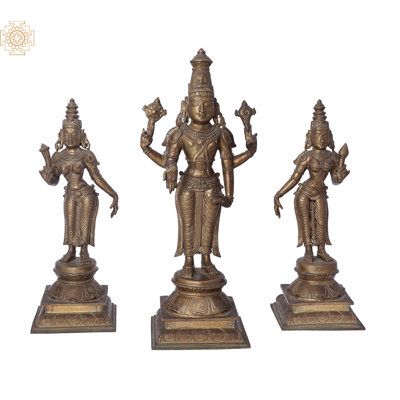A three-deity ensemble to grace your home or office temple. Lord Perumal, as the great Vishnu is worshipped in South India, stands between His wives, Shri Devi and Bhu Devi. The figurines are discrete: each stands upon its own pedestal, which is an upturned lotus with its mouth against a two-tiered, quadrilateral plinth. | Exotic India Perumal Sri Devi Statue Metal in Brown, Size 12.0 H x 5.0 W x 4.0 D in | Wayfair | Home Decor