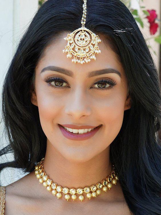 emphasis on the eyes and lips with a sheer finish to the makeup.