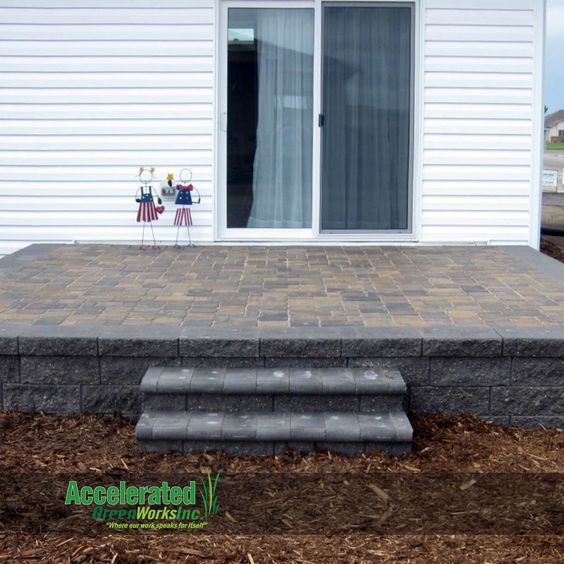 Raised Paver Patio With Steps To The Landscaping Versa Lok Block Raised Paver Patio With Steps To The Landscaping Versa Lok Block Retaining Wall And Traditional 3 Stone Random Cobblestone Pattern Inlay