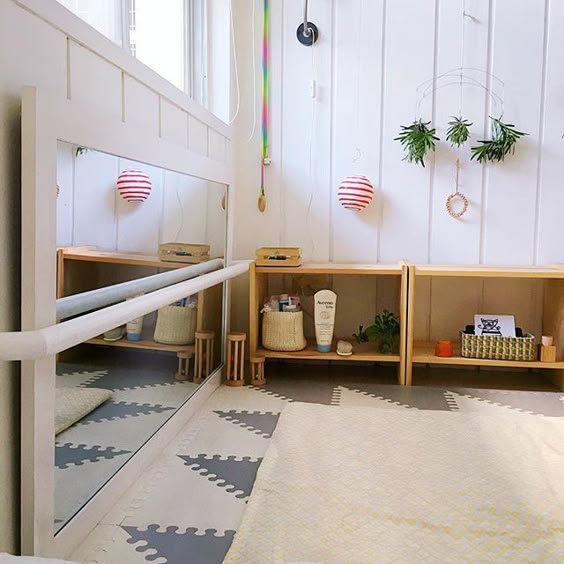 The pull up bar across the floor mirror is the classic Montessori nursery addition for a mobile baby. It's not there for us to