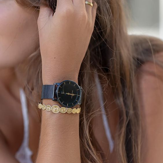 La MINIMES est un garde temps à la modernité assumée. De par simplicité et son minimalisme, il se glisse avec aisance dans toutes les situations et s\'adapte à la perfection au poignet féminin. Diamètre : 39mm Entrecorne : 20mm Mouvement : Quartz Boîtier : Acier PDV noir Cadran : Noir + sous-compteur noir Index rose gold et verre minéral Bracelet : Acier Milanais - Cuir Noir Fonctions : 2 Aiguilles, Petite Seconde Étanchéité : 3 BAR | 30m Fermoir : Fermoir coulissant Référence : HMN 123-3AMR & HC
